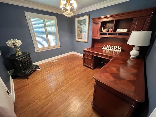 office with built in desk, ornamental molding, light wood-type flooring, and an inviting chandelier