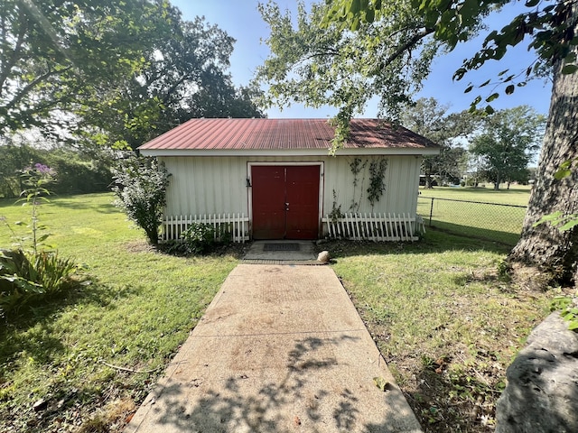 view of outbuilding featuring a yard