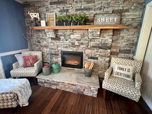 living area with a fireplace and dark hardwood / wood-style flooring