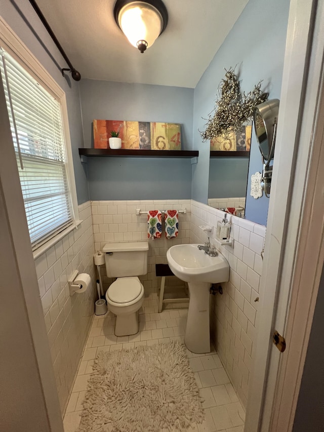 bathroom featuring tile walls, toilet, and tile patterned flooring