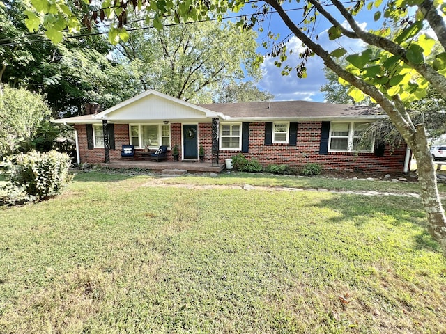 ranch-style house with covered porch and a front yard