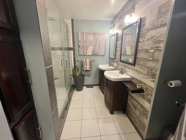 bathroom featuring vanity, tile walls, tile patterned floors, and a shower with door