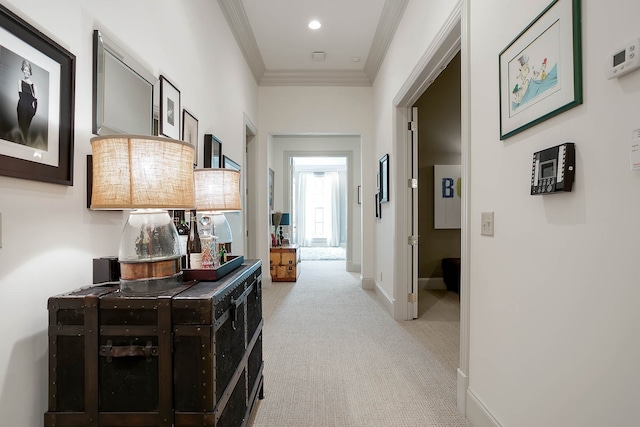 corridor with crown molding and light carpet