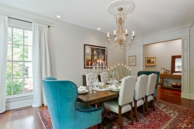 dining room featuring a wealth of natural light, hardwood / wood-style floors, and a chandelier