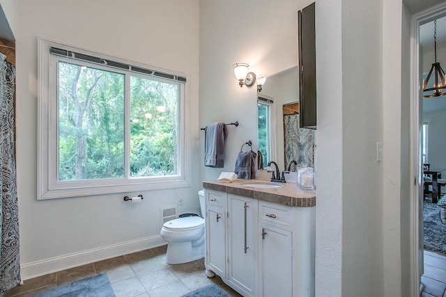 bathroom with tile patterned flooring, toilet, and vanity