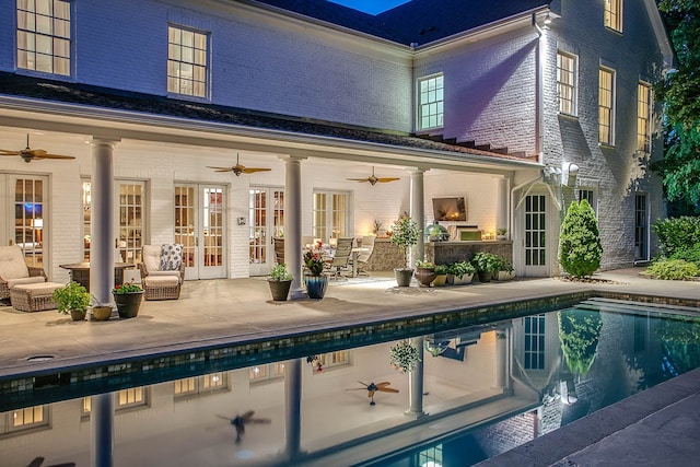 view of swimming pool featuring french doors, ceiling fan, outdoor lounge area, and a patio