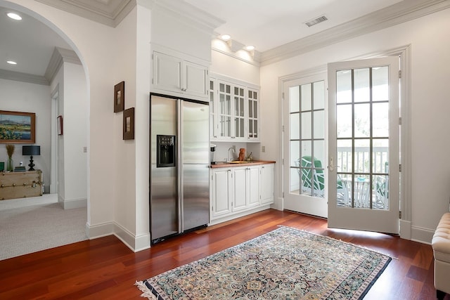 doorway featuring crown molding, sink, and dark hardwood / wood-style floors