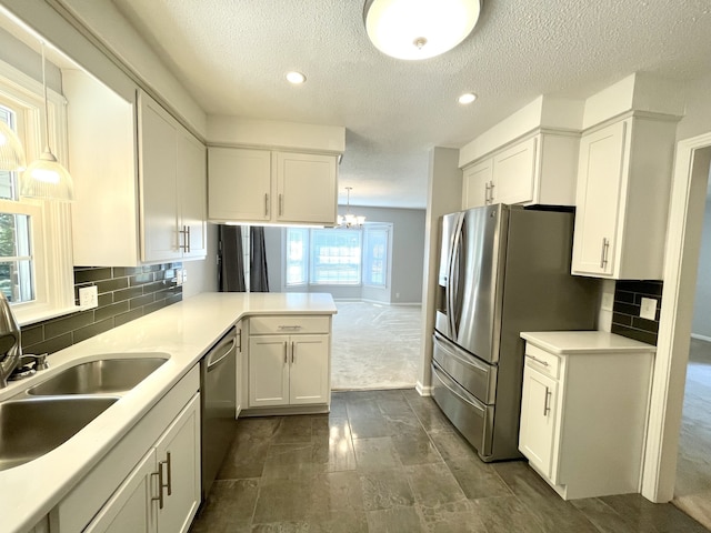 kitchen with plenty of natural light, sink, decorative light fixtures, and tasteful backsplash