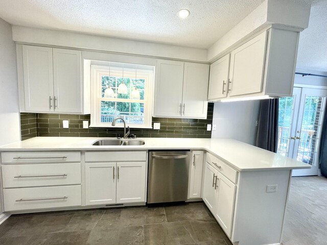 kitchen with dishwasher, white cabinetry, a healthy amount of sunlight, and sink