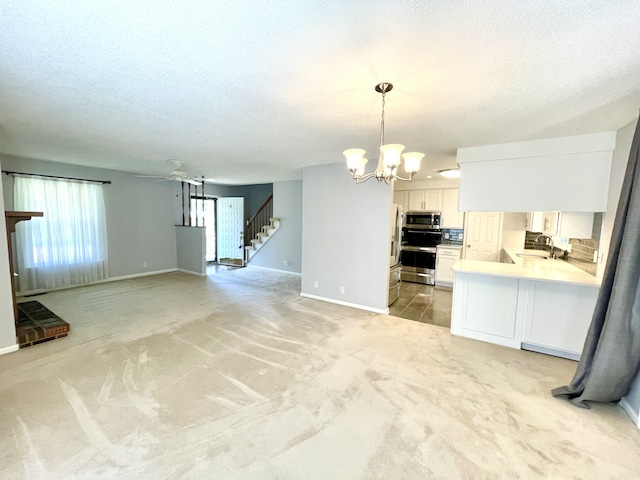 unfurnished living room featuring light carpet and a textured ceiling