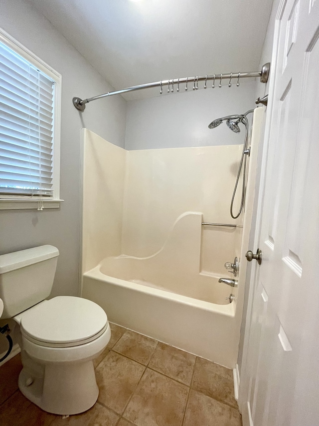 bathroom with shower / bath combination, toilet, and tile patterned floors