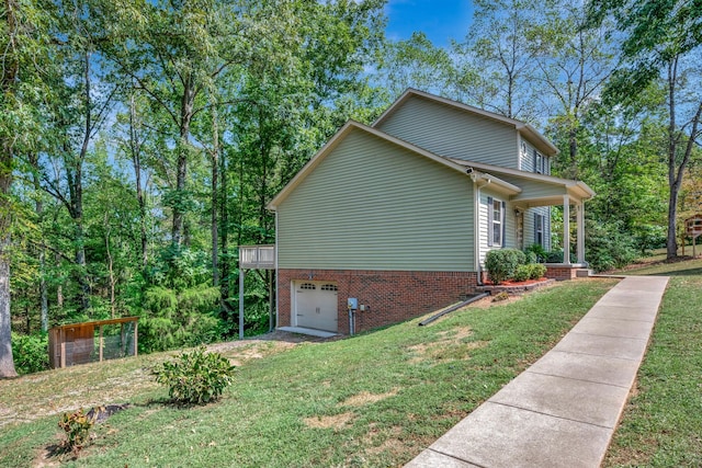 view of home's exterior featuring a garage, a porch, and a lawn