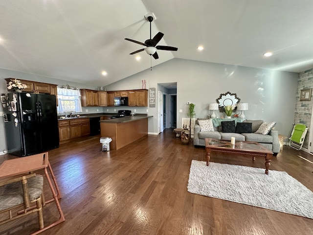 living room with dark hardwood / wood-style flooring, sink, ceiling fan, and lofted ceiling