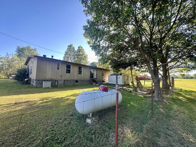 view of front of house with a storage shed and a front yard