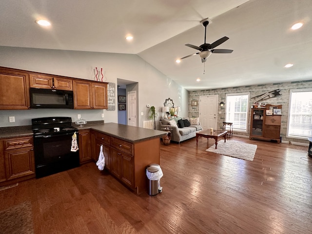 kitchen with vaulted ceiling, black appliances, dark wood-type flooring, kitchen peninsula, and ceiling fan