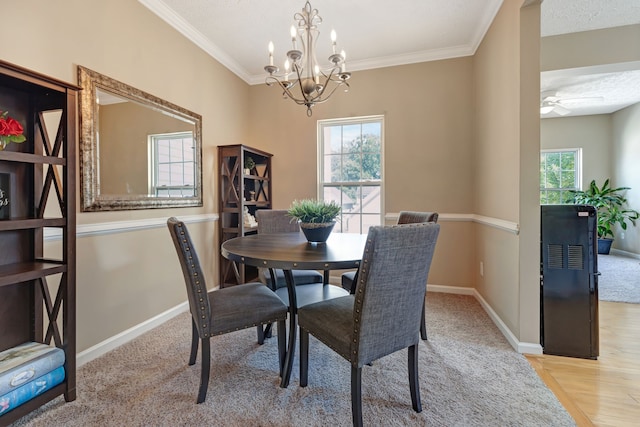 dining area with an inviting chandelier, crown molding, and light hardwood / wood-style floors