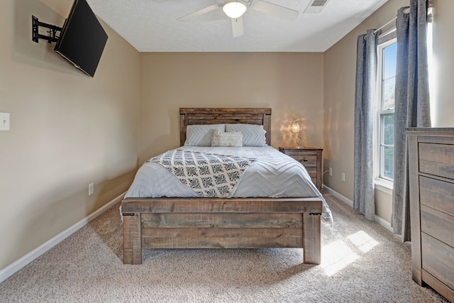 carpeted bedroom with ceiling fan and multiple windows