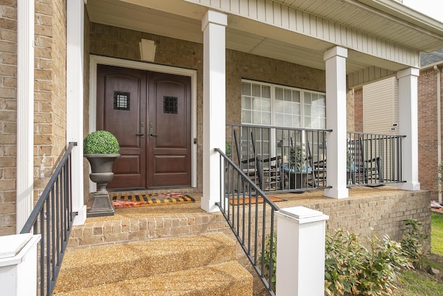 view of exterior entry with covered porch