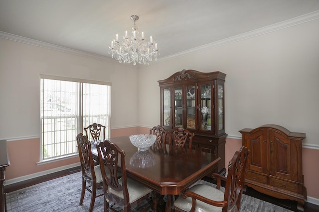 dining room featuring hardwood / wood-style flooring, ornamental molding, and an inviting chandelier