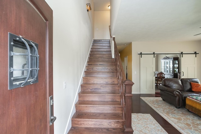 staircase featuring a barn door