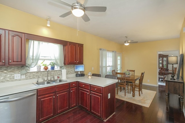 kitchen featuring dishwasher, a healthy amount of sunlight, dark hardwood / wood-style flooring, sink, and ceiling fan