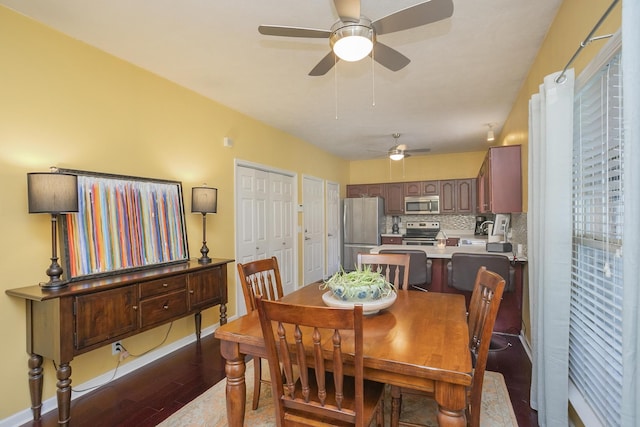 dining area with dark wood-type flooring, sink, and ceiling fan