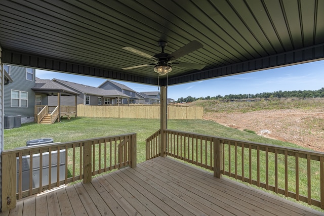 wooden deck featuring a lawn, ceiling fan, and central air condition unit