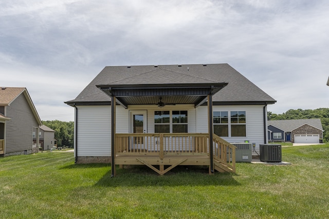 back of property with cooling unit, ceiling fan, a lawn, and a deck