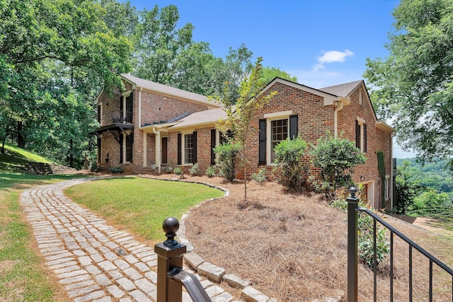 5053 Villa Crest Dr, Nashville, TN 37220 - view of front of home with brick siding, a front lawn, and a balcony