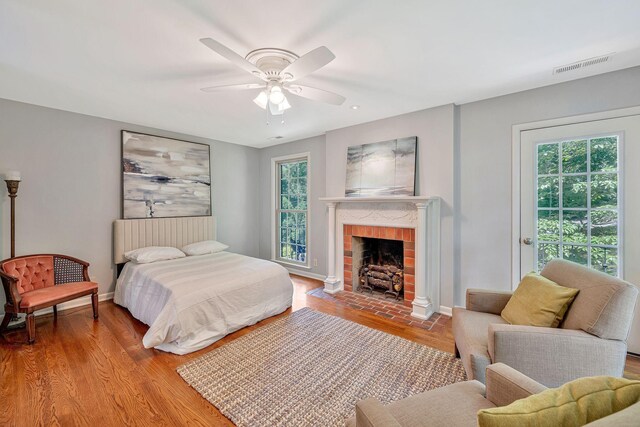 5053 Villa Crest Dr, Nashville, TN 37220 - bedroom featuring a brick fireplace, wood finished floors, ceiling fan, and access to outside