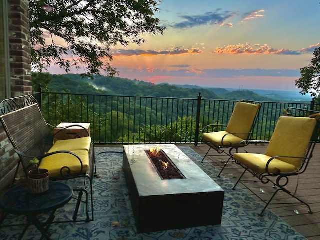 patio terrace at dusk featuring a fire pit
