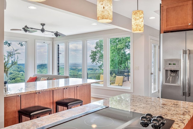 5053 Villa Crest Dr, Nashville, TN 37220 - kitchen with light stone counters, decorative light fixtures, stainless steel refrigerator with ice dispenser, a ceiling fan, and recessed lighting