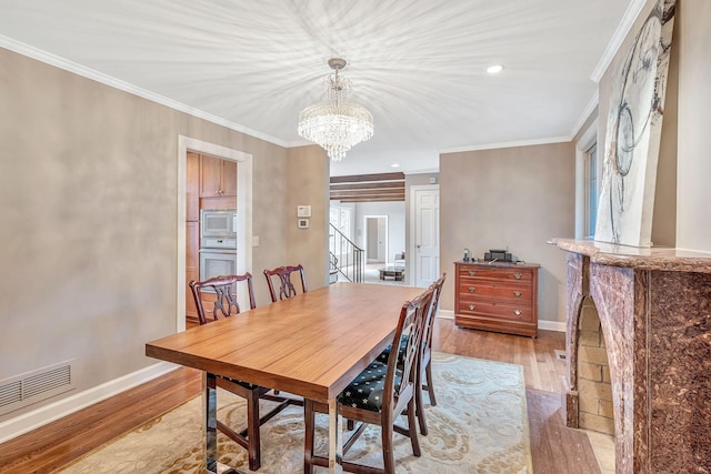 5053 Villa Crest Dr, Nashville, TN 37220 - dining area with a chandelier, crown molding, light wood-style flooring, and recessed lighting