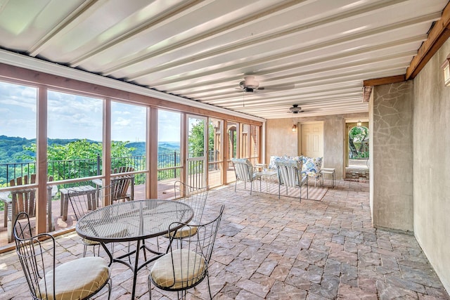 5053 Villa Crest Dr, Nashville, TN 37220 - sunroom with outdoor dining space, stone finish flooring, ceiling fan, and a mountain view