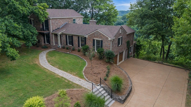 5053 Villa Crest Dr, Nashville, TN 37220 - traditional-style house featuring concrete driveway, brick siding, an attached garage, a front yard, and a chimney