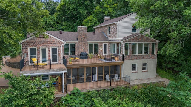 5053 Villa Crest Dr, Nashville, TN 37220 - rear view of house featuring brick siding, a sunroom, a chimney, and a patio