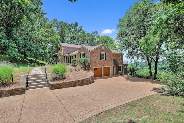 5053 Villa Crest Dr, Nashville, TN 37220 - view of front facade featuring an attached garage, brick siding, and concrete driveway