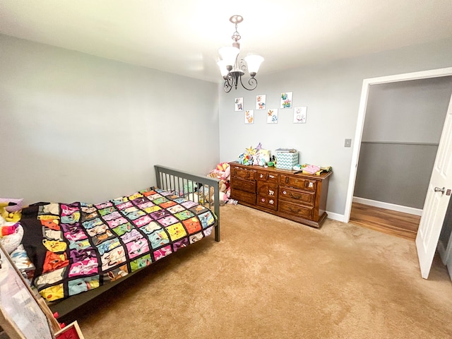 bedroom featuring light carpet and a notable chandelier