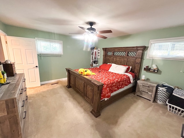 bedroom with ceiling fan and light colored carpet