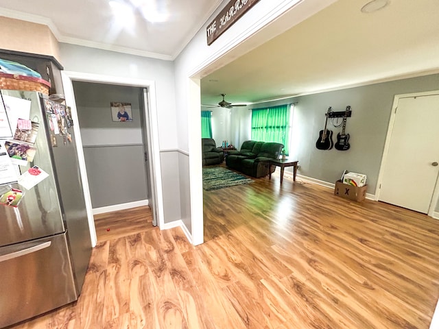 kitchen with ceiling fan, ornamental molding, stainless steel fridge, and light hardwood / wood-style flooring