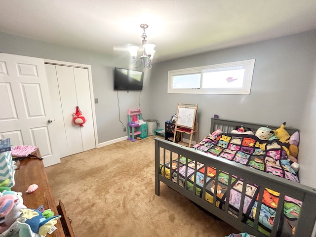 bedroom featuring a closet, light carpet, and a notable chandelier