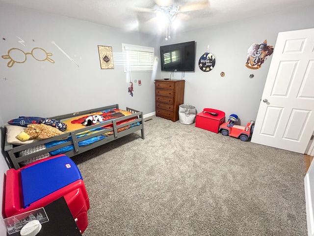 carpeted bedroom featuring a textured ceiling and ceiling fan