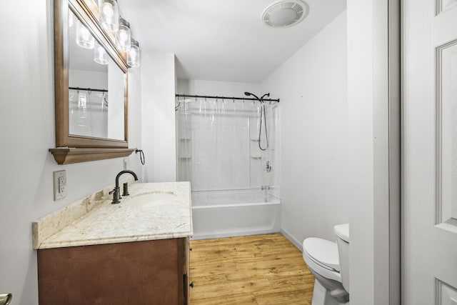 full bathroom with toilet, hardwood / wood-style flooring, shower / tub combo, and vanity