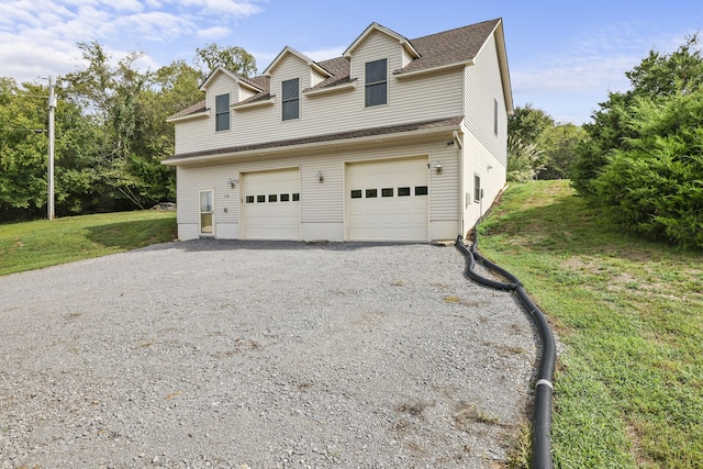 view of front of home with a front lawn and a garage