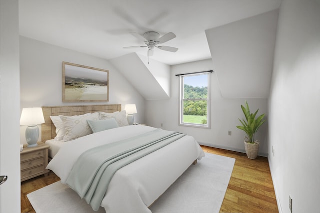 bedroom featuring ceiling fan, light hardwood / wood-style floors, and vaulted ceiling