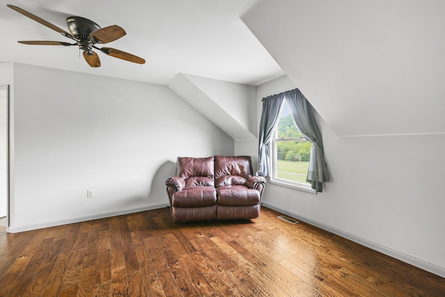 living area with lofted ceiling, dark wood-type flooring, and ceiling fan