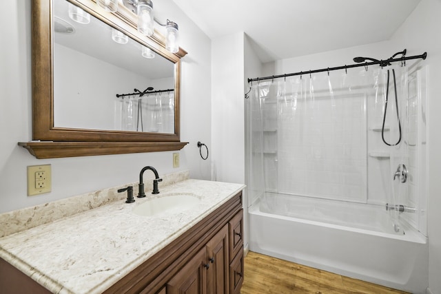 bathroom featuring vanity, shower / bath combo with shower curtain, and hardwood / wood-style floors