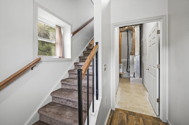 staircase with hardwood / wood-style floors