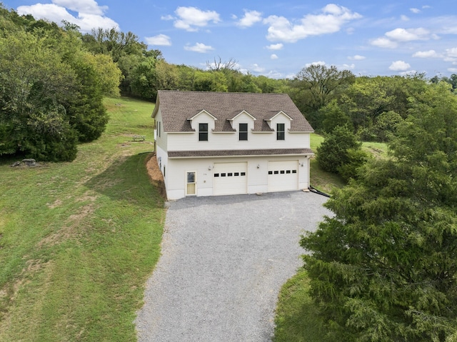 view of front of home featuring a front yard and a garage