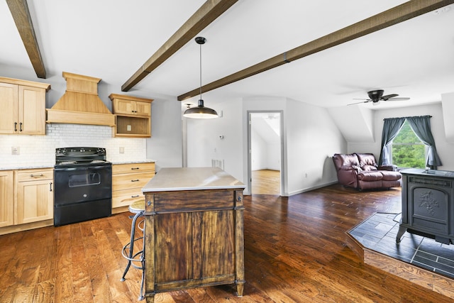 kitchen with a center island, premium range hood, dark wood-type flooring, ceiling fan, and black range with electric cooktop